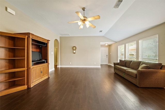 1928 Cypress Ln, Dayton, TX 77535 - living room featuring a ceiling fan, arched walkways, dark wood-style flooring, vaulted ceiling, and baseboards