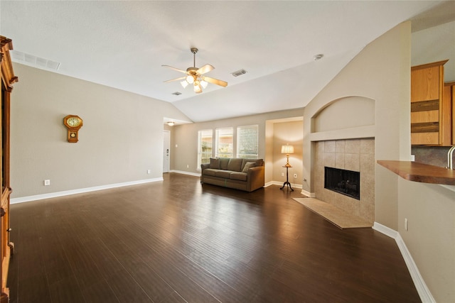 1928 Cypress Ln, Dayton, TX 77535 - living area with ceiling fan, a fireplace, vaulted ceiling, dark wood finished floors, and baseboards