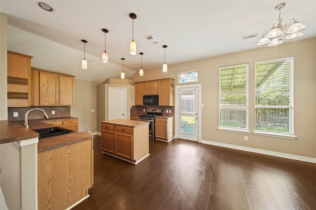 1928 Cypress Ln, Dayton, TX 77535 - kitchen with stainless steel gas range oven, a sink, black microwave, backsplash, and dark wood-style flooring