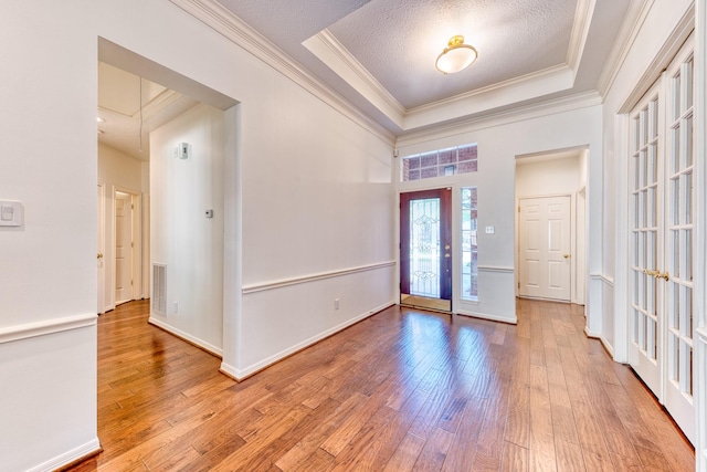 1114 Ridgeburg Ct, Houston, TX 77077 - entrance foyer featuring a tray ceiling, crown molding, wood-type flooring, french doors, and a textured ceiling