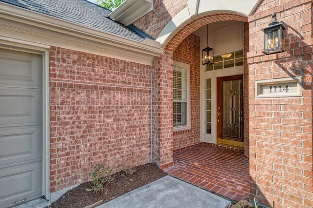 1114 Ridgeburg Ct, Houston, TX 77077 - view of exterior entry featuring brick siding, a shingled roof, and a porch