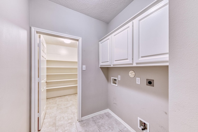 1114 Ridgeburg Ct, Houston, TX 77077 - washroom with electric dryer hookup, hookup for a washing machine, light tile patterned floors, a textured ceiling, and cabinet space