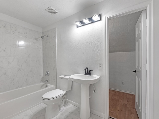 126 Oryan Ct, Houston, TX 77015 - bathroom with toilet, baseboards, shower / tub combination, a textured ceiling, and wood finished floors
