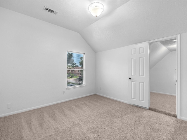 126 Oryan Ct, Houston, TX 77015 - bonus room featuring carpet floors, vaulted ceiling, a textured ceiling, and baseboards
