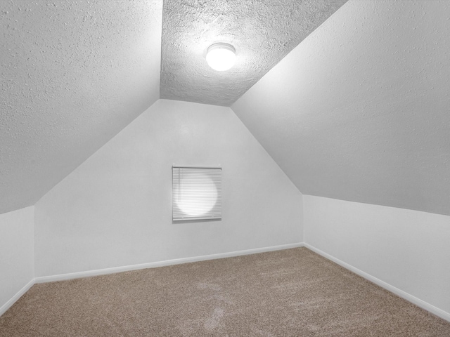 126 Oryan Ct, Houston, TX 77015 - bonus room featuring a textured ceiling, carpet, lofted ceiling, and baseboards