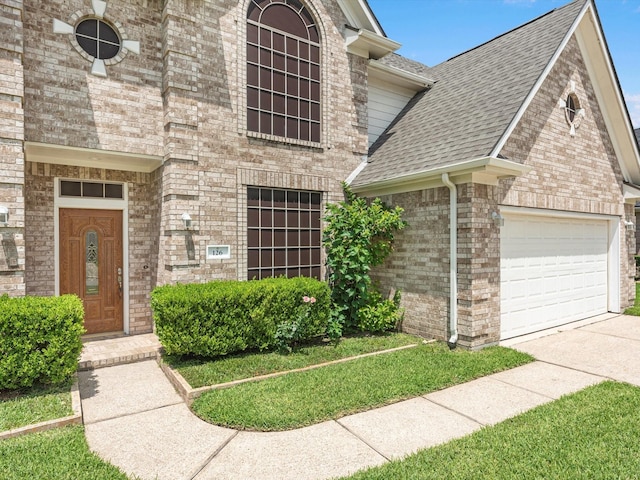 126 Oryan Ct, Houston, TX 77015 - view of front of house with roof with shingles, brick siding, an attached garage, and driveway