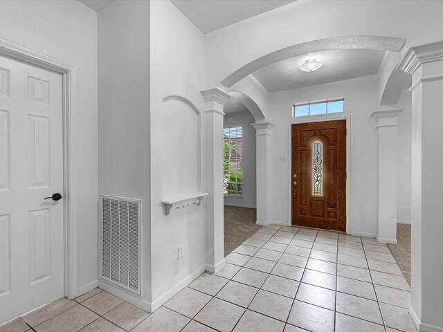 126 Oryan Ct, Houston, TX 77015 - entryway with decorative columns, light tile patterned floors, arched walkways, and baseboards