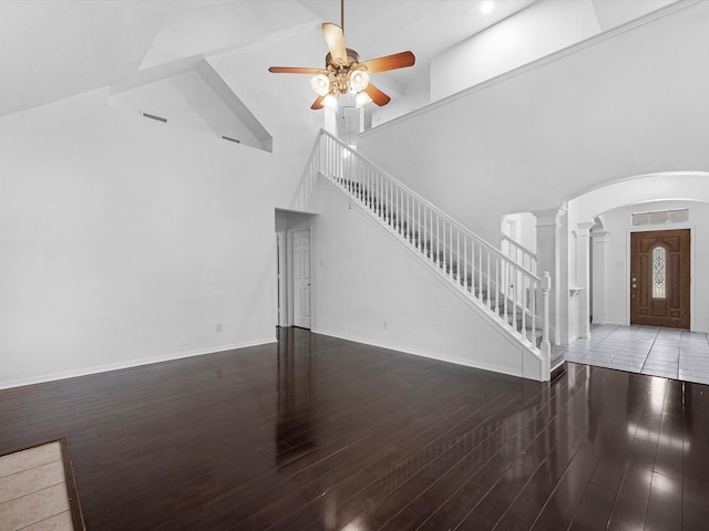 126 Oryan Ct, Houston, TX 77015 - unfurnished living room featuring a ceiling fan, wood finished floors, arched walkways, high vaulted ceiling, and stairs