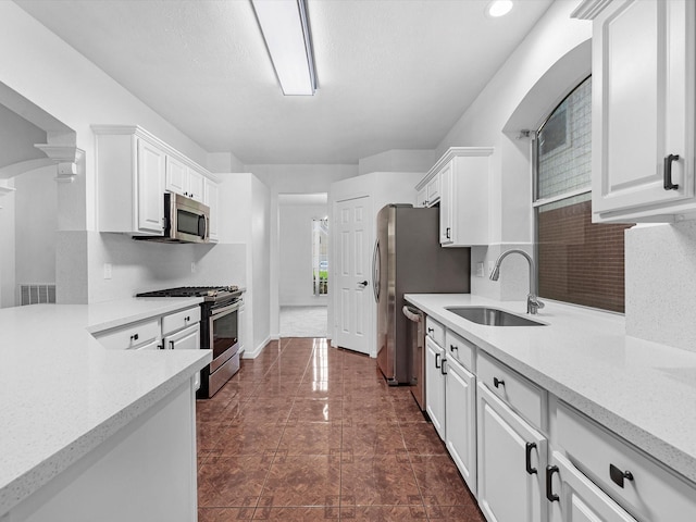 126 Oryan Ct, Houston, TX 77015 - kitchen featuring stainless steel appliances, a sink, light countertops, and white cabinetry