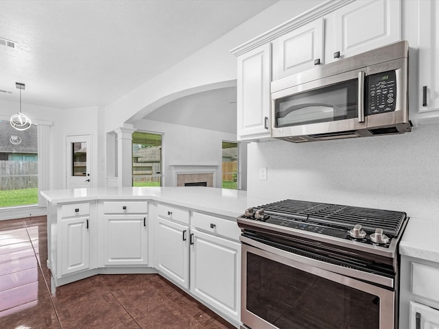 126 Oryan Ct, Houston, TX 77015 - kitchen with stainless steel appliances, arched walkways, ornate columns, light countertops, and a peninsula