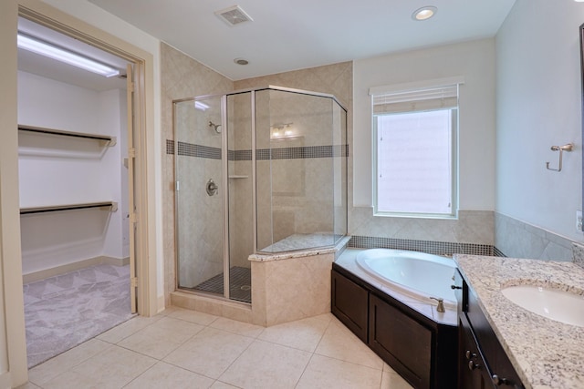 1184 Nelson Falls Ln, Houston, TX 77008 - bathroom with a shower stall, a garden tub, tile patterned flooring, a spacious closet, and vanity