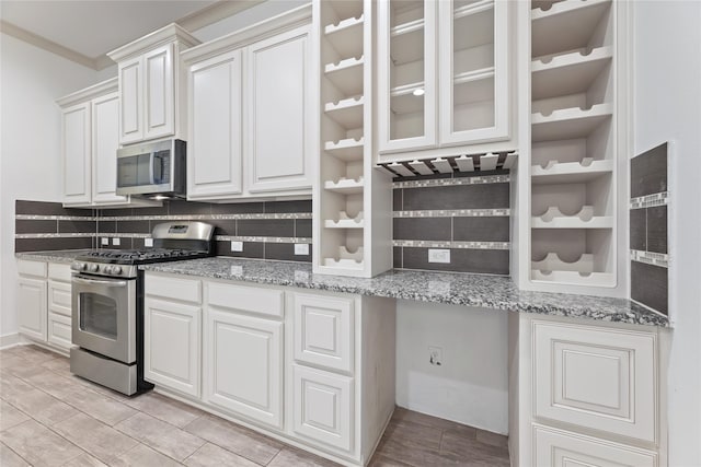1184 Nelson Falls Ln, Houston, TX 77008 - kitchen featuring appliances with stainless steel finishes, tasteful backsplash, white cabinetry, light stone countertops, and light wood finished floors
