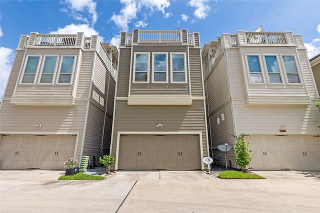 1184 Nelson Falls Ln, Houston, TX 77008 - view of front facade featuring a garage, concrete driveway, and a balcony