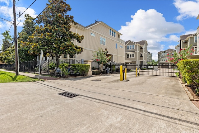 1184 Nelson Falls Ln, Houston, TX 77008 - view of concrete street featuring a residential view, a gate, and a gated entry