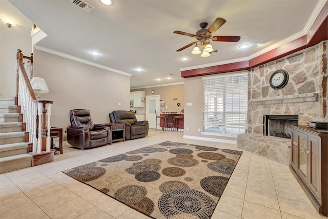 9822 El Chaco St, Baytown, TX 77521 - tiled living area with ornamental molding, ceiling fan, stairs, recessed lighting, and a fireplace