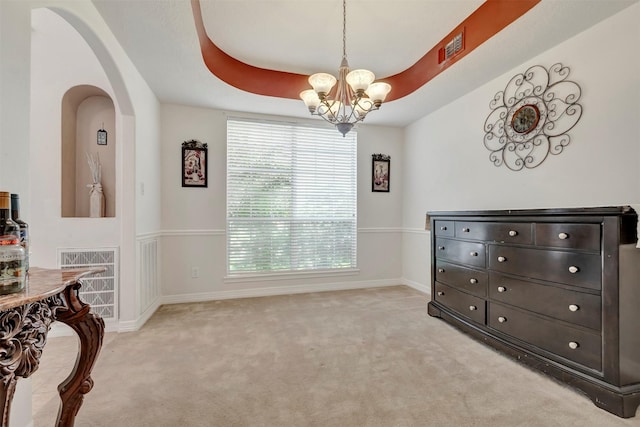 9822 El Chaco St, Baytown, TX 77521 - dining room with a chandelier, light colored carpet, baseboards, and arched walkways