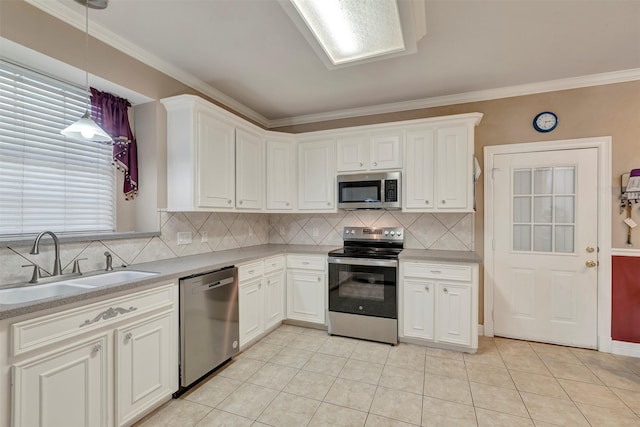 9822 El Chaco St, Baytown, TX 77521 - kitchen with stainless steel appliances, a sink, decorative backsplash, white cabinetry, and crown molding