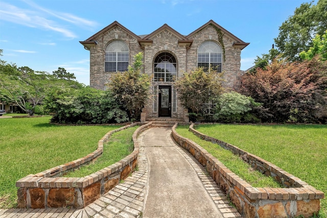 9822 El Chaco St, Baytown, TX 77521 - view of front of home with a front lawn and brick siding