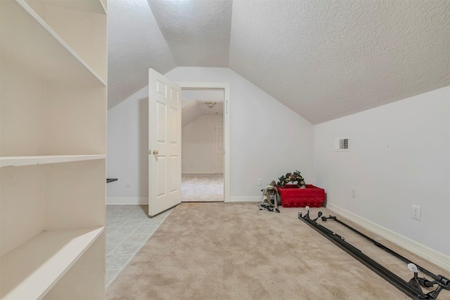 9822 El Chaco St, Baytown, TX 77521 - bonus room with a textured ceiling, vaulted ceiling, baseboards, and light carpet