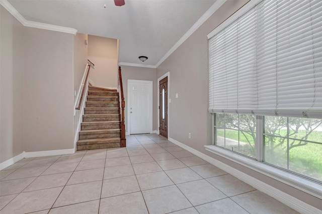 9822 El Chaco St, Baytown, TX 77521 - entryway featuring light tile patterned flooring, ornamental molding, stairway, baseboards, and ceiling fan