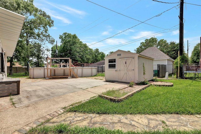 9822 El Chaco St, Baytown, TX 77521 - view of yard featuring a storage shed, a patio, an outdoor structure, and a trampoline