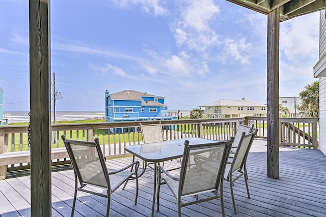 wooden deck featuring outdoor dining area and a water view