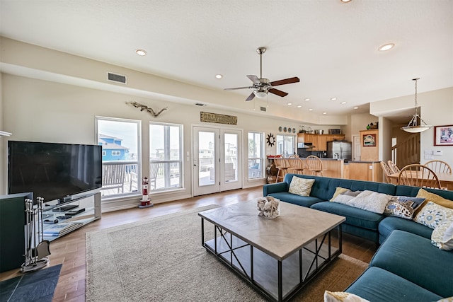 living room with a ceiling fan, wood finished floors, and recessed lighting
