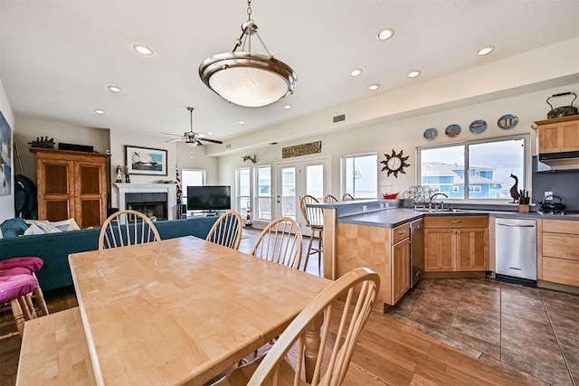 dining space featuring a ceiling fan, recessed lighting, and a tile fireplace