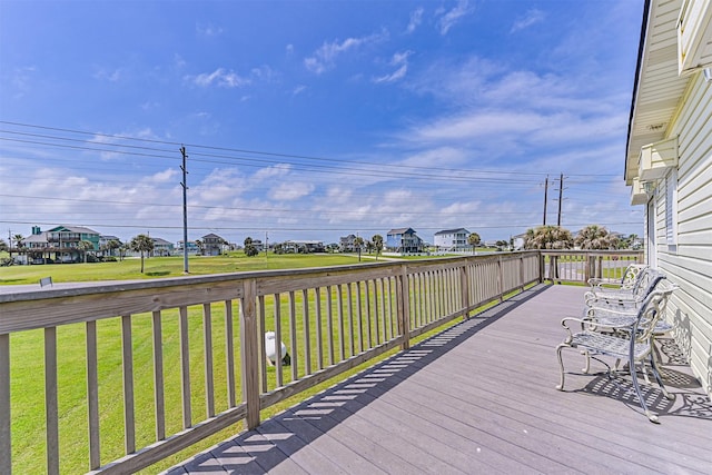 deck with a yard and a residential view