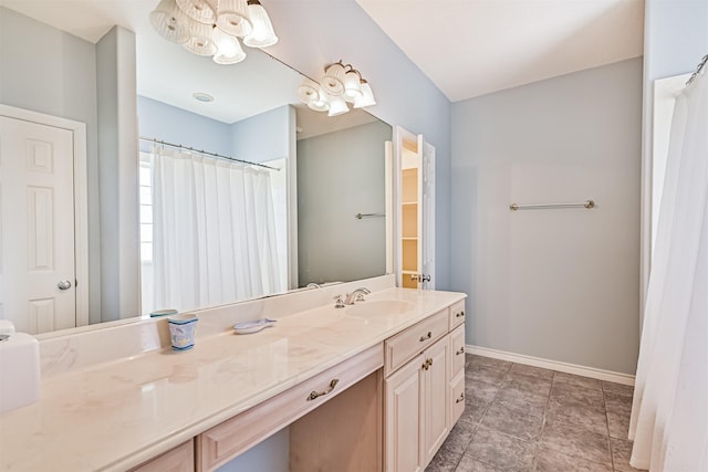bathroom featuring a chandelier, vanity, baseboards, and a shower with shower curtain