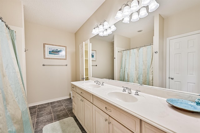 bathroom featuring baseboards and double vanity