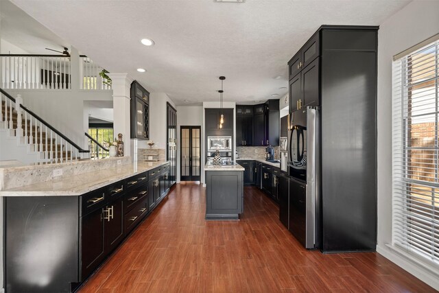14902 Autumnvale Ln, Cypress, TX 77429 - kitchen featuring plenty of natural light, dark wood-style floors, a kitchen island, tasteful backsplash, and recessed lighting