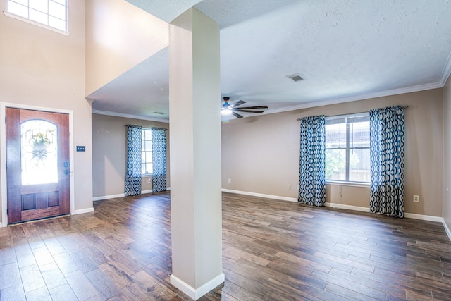 10835 Spruce Dr S, La Porte, TX 77571 - foyer with wood finished floors, ceiling fan, crown molding, baseboards, and a textured ceiling
