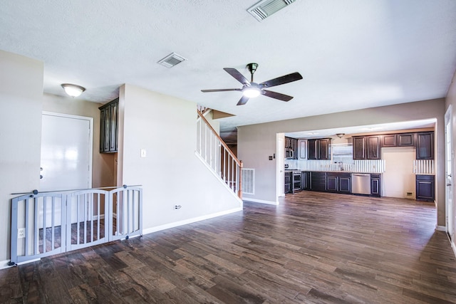 10835 Spruce Dr S, La Porte, TX 77571 - unfurnished living room with ceiling fan, dark wood-style flooring, baseboards, and stairway