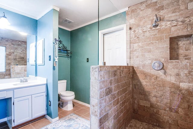 10835 Spruce Dr S, La Porte, TX 77571 - bathroom with ornamental molding, tiled shower, tile patterned floors, toilet, and vanity