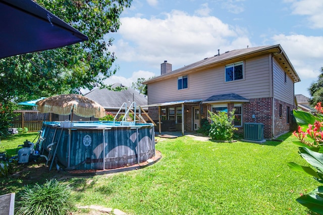 10835 Spruce Dr S, La Porte, TX 77571 - rear view of property featuring brick siding, a chimney, and cooling unit