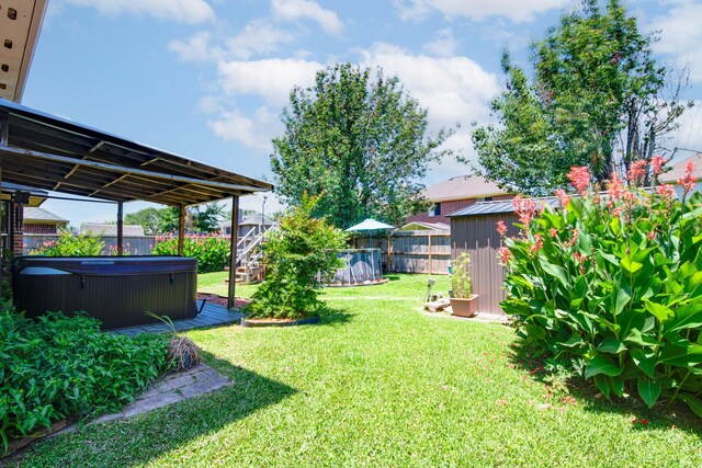 10835 Spruce Dr S, La Porte, TX 77571 - view of yard with a hot tub, a storage shed, and an outdoor structure