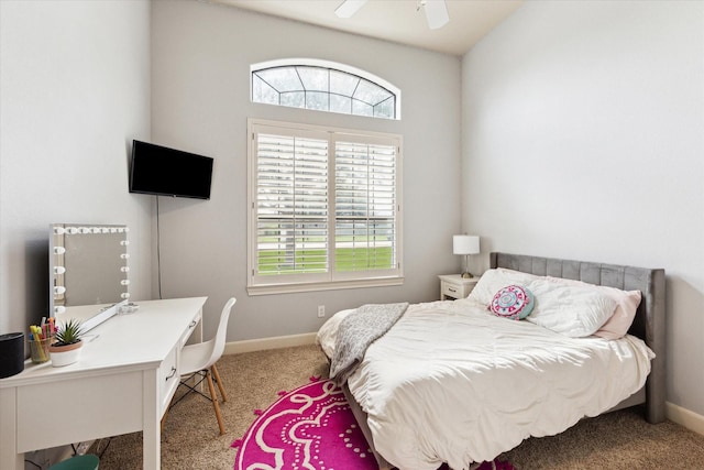 carpeted bedroom featuring baseboards, an office area, and a ceiling fan