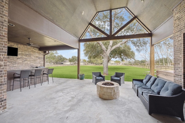 view of patio / terrace with an outdoor living space with a fire pit and ceiling fan