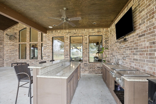 view of patio / terrace with exterior kitchen and ceiling fan