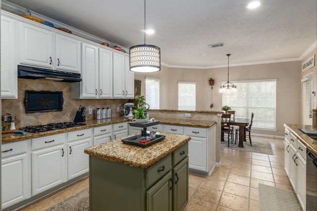 12127 Via San Rocco Ct, Cypress, TX 77429 - kitchen featuring gas cooktop, under cabinet range hood, stone tile floors, green cabinetry, and crown molding