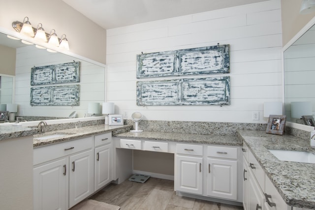 12127 Via San Rocco Ct, Cypress, TX 77429 - bathroom featuring wood walls, wood finished floors, and vanity