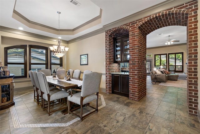 9010 Kapri Ln, Houston, TX 77025 - dining space with crown molding, a chandelier, a tray ceiling, baseboards, and ceiling fan
