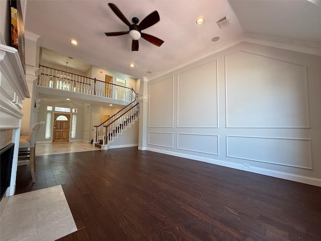 2810 Bright Trl, Sugar Land, TX 77479 - unfurnished living room featuring a decorative wall, a ceiling fan, dark wood-style flooring, a fireplace with flush hearth, and stairway