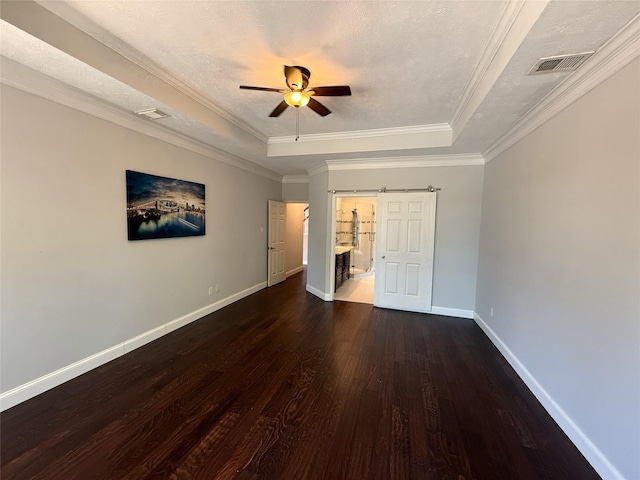 2810 Bright Trl, Sugar Land, TX 77479 - unfurnished bedroom with a tray ceiling, dark wood finished floors, baseboards, ornamental molding, and ensuite bathroom