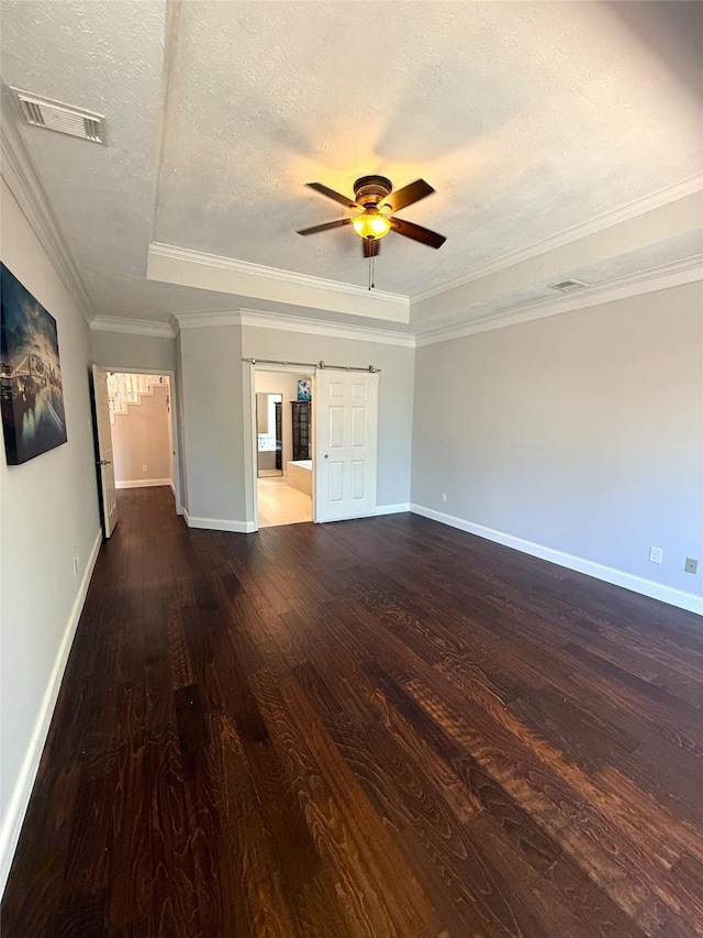 2810 Bright Trl, Sugar Land, TX 77479 - unfurnished room with a barn door, ceiling fan, wood finished floors, a textured ceiling, and baseboards