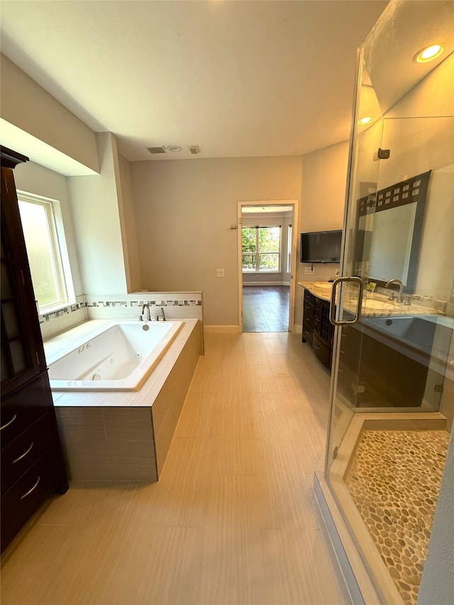 2810 Bright Trl, Sugar Land, TX 77479 - full bathroom featuring a shower stall, vanity, a jetted tub, and baseboards
