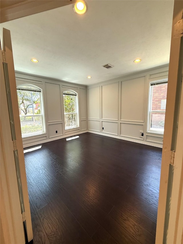 2810 Bright Trl, Sugar Land, TX 77479 - spare room with a decorative wall, healthy amount of natural light, dark wood-type flooring, recessed lighting, and a baseboard radiator