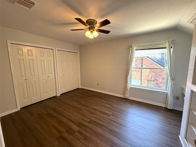 2810 Bright Trl, Sugar Land, TX 77479 - unfurnished bedroom featuring dark wood-type flooring, multiple closets, baseboards, and a ceiling fan