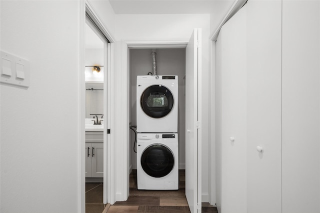 2744 Briarhurst Dr Unit 33, Houston, TX 77057 - clothes washing area with stacked washing machine and dryer and dark wood finished floors
